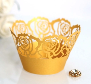 Golden laser-cut cupcake wrapper with rose patterns for elegant wedding table decor