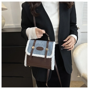 Close-up of brown leather and grey denim patchwork bag with white plush fleece trim