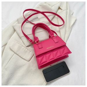 Detail of rose pink quilted crossbody bag with golden hardware and round top handle