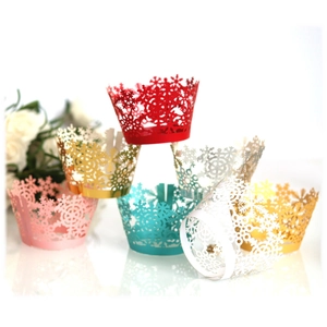 Laser-cut snowflake cupcake wrappers in multiple vibrant colors for holiday parties
