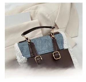 Detail of adjustable golden buckle on faux shearling and denim patchwork backpack