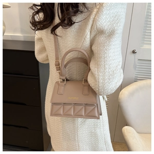 Beige quilted small crossbody bag styled with a minimalist outfit for a casual look