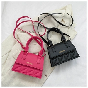 Flat lay of pink and black mini crossbody bags with triangular quilted texture details