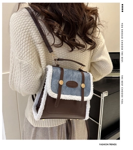 Detail of the lamb wool trim and gold buckle on a retro brown faux leather backpack
