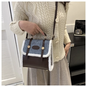 Detail shot of the lamb wool trim and vintage leather patchwork on the crossbody bag