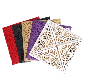 Laser-cut floral invitation cards in multiple colors including black, gold, and white