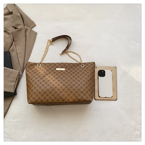 Detail of vintage large capacity tote bag with star pattern and chain leather strap