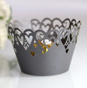 Close-up of laser-cut heart pattern pearlescent cupcake wrappers in elegant dark grey