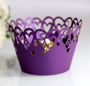 Close-up of laser-cut heart pattern cupcake wrapper in elegant deep purple