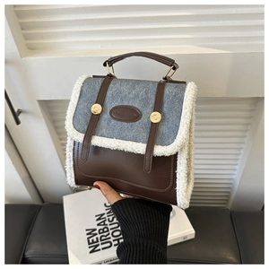 Detail showing the brown leather and grey felt stitching with white fleece trim