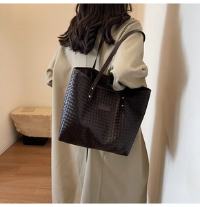 Close-up of dark brown large woven tote bag featuring classic intrecciato craftsmanship