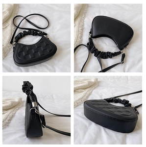 Detailed views of a black ruched handbag with grainy PU leather and pleated handle design