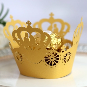 Golden laser-cut lace cupcake wrappers featuring royal carriage and crown designs