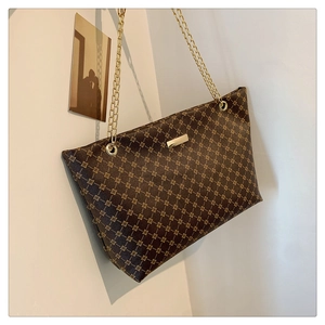 Close-up of vintage printed tote bag with large capacity and elegant gold chain straps