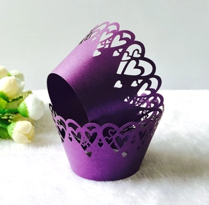 Detail of purple pearlescent paper cupcake wrappers with laser-cut heart pattern