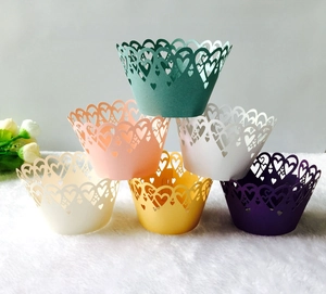 Detail view of laser-cut heart cupcake wrappers in multiple pastel colors for parties