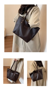 Detailed macro view of woven leather texture on dark brown large tote bag for women