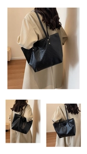 Macro detail of black woven leather tote bag texture with elegant gold hardware rivets
