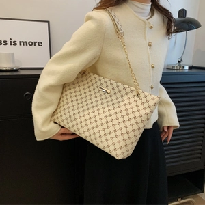 Beige tote bag with vintage floral patterns and golden chain strap for daily commute
