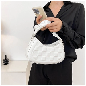 Close-up of a white textured leather shoulder bag featuring stylish ruched handle detail