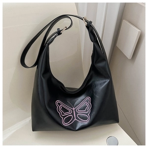 Detail of black faux leather hobo bag with pink butterfly embroidery and adjustable strap