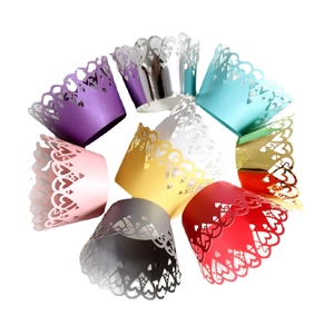 Laser cut pearlescent cupcake wrappers with heart patterns in various bright colors