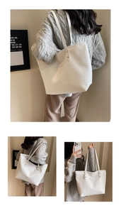 Detail of white large woven tote bag with diamond lattice pattern and reinforced rivets