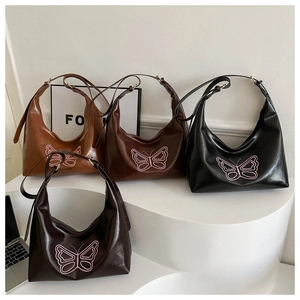 Detail view of four butterfly embroidered tote bags in black, coffee, brown and tan