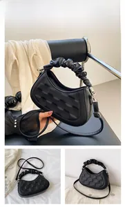 Detail of black quilted leather hobo bag with unique ruched handle and silver hardware