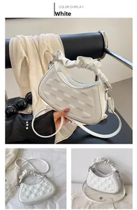 Detail of white semi-circle handbag with checkerboard embossing and scrunchie handle