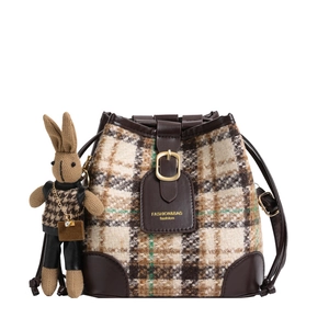 Chic tweed bucket bag with leather trim and cute rabbit charm in 45-degree view