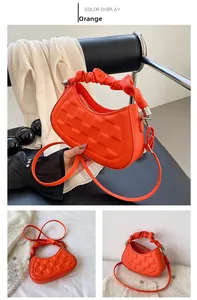 Detailed views of an orange quilted litchi leather handbag with pleated handle