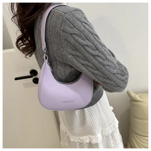 Detail view of the fashion lavender crescent shoulder bag with elegant leather texture