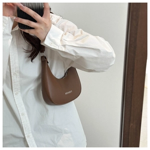 Mirror selfie showing the fit and size of a brown PU leather half-moon shoulder bag