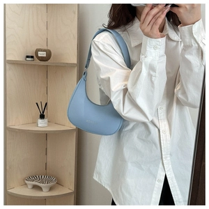 Light blue crescent shoulder bag with FASHION lettering in a mirror selfie style