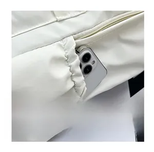 Detailed side view of nylon backpack featuring a flexible elastic pocket for smartphones