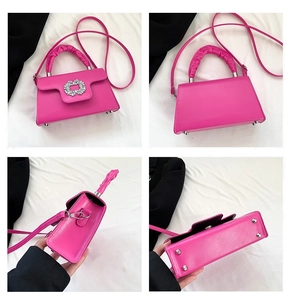 Detail view of fuchsia PU leather crossbody bag featuring diamond buckle and ruffled handle