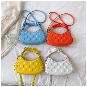 Detail view of multi-colored textured crossbody bags with stylish ruched handles