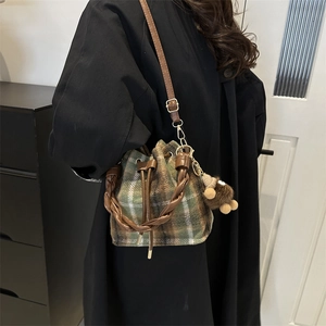 Vintage green plaid wool bucket bag with woven handle and brown bear pendant