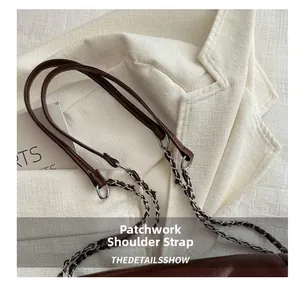 Detailed shot of dark brown handbag featuring a mixed leather and metal chain strap