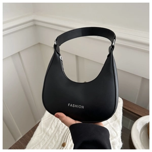 Detail of a black crescent hobo bag with white FASHION print and metallic zipper
