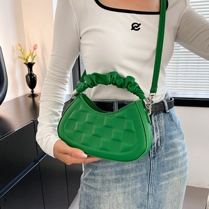 Vibrant green textured crossbody bag with ruched cloud handle and silver buckle detail