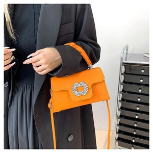 Vibrant orange square crossbody bag with a rhinestone buckle and long shoulder strap
