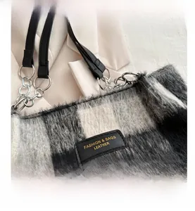 Detail of plaid tote bag featuring plush faux fur texture and leather logo patch