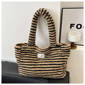 Detail of soft black and yellow striped plush tote bag with foun foun party label