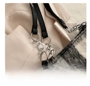 Detail of plush grey faux fur tote with leather shoulder strap and metallic ring buckle
