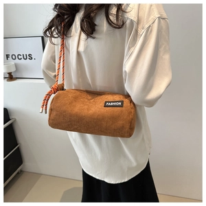 Brown corduroy cylindrical crossbody bag with woven rope strap and Fashion label