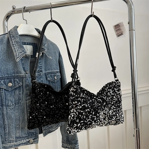 Sleek sequin crossbody shoulder bags in black and silver gradient on a metal display rack