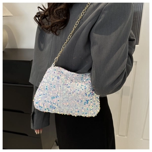 Detailed close-up of a white sequin crossbody bag featuring a golden metal chain strap