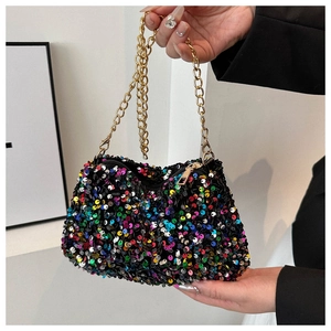 Close-up of colorful sequin evening bag with gold chain strap held by a model